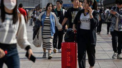 China's economic woes dampen 'Golden Week' holiday travel