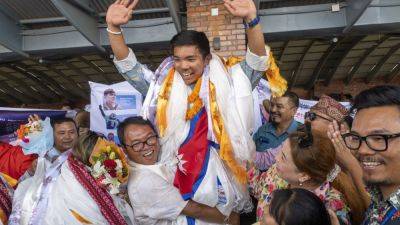 A record-setting teen climber returns home to Nepal to a hero’s welcome