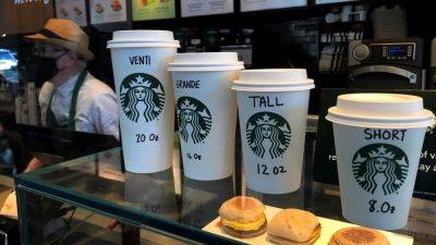 Starbucks shares slide after coffee chain says sales fell again, suspends outlook