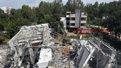 Building collapses during heavy rains in southern India city, killing at least 5 workers