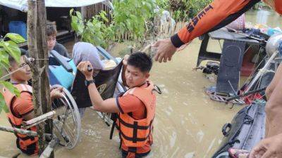 Tropical storm battering Philippines leaves at least 24 people dead in flooding and landslides