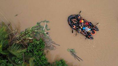 Tropical Storm Trami brings severe flooding and landslides to the Philippines, at least two dozen dead