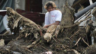 A Philippine town in the shadow of a volcano is hit by landslides it never expected - apnews.com - China - Philippines - Vietnam - city Manila