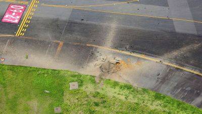 American WWII bomb explodes at Japanese airport, causing large crater in taxiway