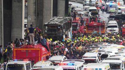 Thai police arrest driver and work to identify victims of the school bus fire that killed 23