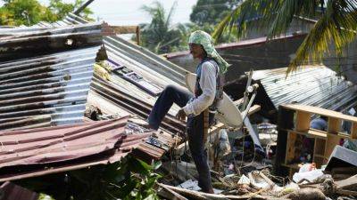 A powerful typhoon nears the Philippines, with many shelters still crammed after a recent storm