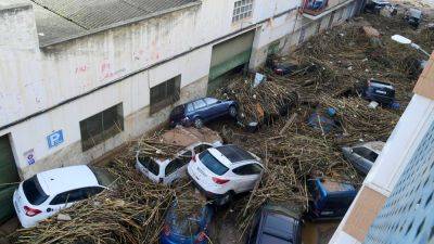 At least 63 people die in devastating flash floods in eastern Spain, officials say