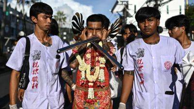 Blood and blades as Thailand celebrates vegetarian festival: ‘body needs to be pierced’