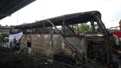 Operator of a Thai bus that caught fire and killed 23 is charged, as investigators suspect gas leak