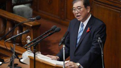 Japan’s new leader expresses regret for governing party slush fund scandal, vows stronger defense