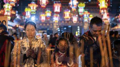 AP PHOTOS: Asia welcomes Lunar New Year of the Dragon with temple visits and celebrations