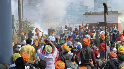 Protesting Indian farmers clash with police for a second day as they march toward the capital
