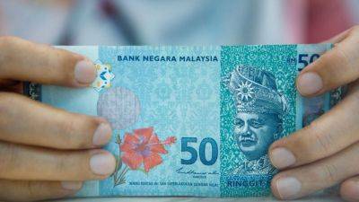 Malaysia ringgit poised for strong rebound to 4.5 versus US dollar by year-end, minister Amir says
