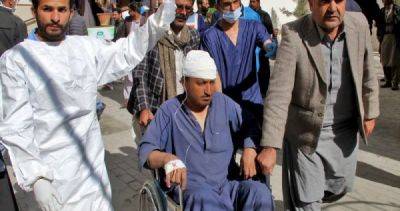Blasts near Pakistan candidates' offices kill 26 on election eve