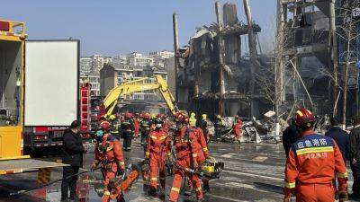 An explosion in a building outside Beijing kills 2 people and injures 26