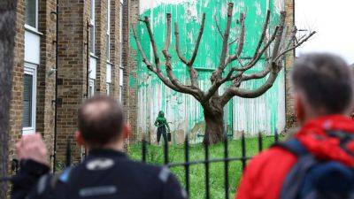New Banksy mural depicting tree foliage appears in north London - cnbc.com - Britain -  London