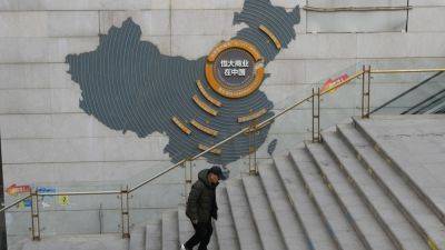 China’s stock watchdog fines property developer Evergrande, slaps lifetime ban on its chairman