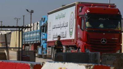Hundreds of trucks full of aid sit idle near border with Gaza as crisis deepens