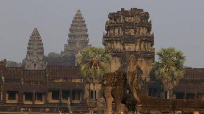 Cambodia defends family relocations for tourism around Angkor Wat temple complex, saying only squatters are being removed