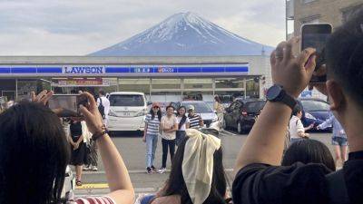 Mount Fuji - To fend off tourists, a town in Japan is building a big screen blocking the view of Mount Fuji - apnews.com - Japan