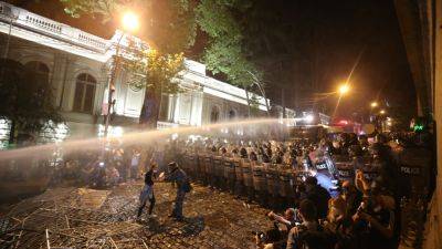 Sophie Kiderlin - Police use tear gas, water cannons and stun grenades on 'foreign agent' bill protesters in Georgia's capital - cnbc.com - Russia - Eu - Georgia