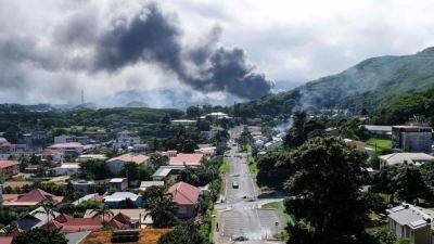Agence FrancePresse - Cars torched, shots fired as riot rocks French Pacific territory of New Caledonia - scmp.com - France -  Paris - New Caledonia -  Noumea