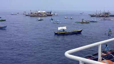 Filipino activists and fishermen sail in 100-boat flotilla to disputed shoal guarded by China - apnews.com - China - Philippines -  Hague -  Beijing -  Manila, Philippines