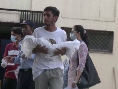 Parents collect their babies who died in New Delhi fire - aljazeera.com -  New Delhi