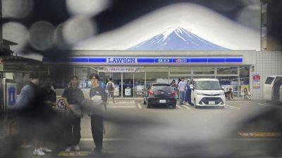 A Japanese town finds holes in a screen built to prevent tourists from snapping photos of Mount Fuji