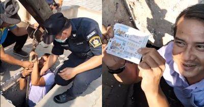 No joke: Crane operator lowers Thai official into manhole to help woman retrieve winning lottery ticket - asiaone.com - Thailand