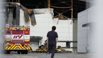 South Korean rescuers search burned factory after a blaze killed 22, mostly Chinese migrants