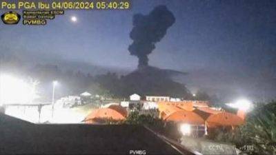 Indonesia’s Mount Ibu erupts, spewing red lava, thick ash and dark clouds into the sky