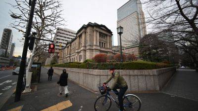Bank of Japan raises benchmark interest rate, outlines roadmap for trimming bond buying program