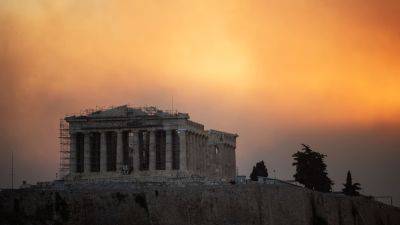 Photos show massive wildfire raging in Greece as residents near Athens forced to flee homes