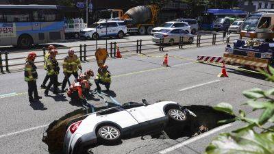 A sinkhole swallows an SUV in South Korea, injuring 2 people - apnews.com - Malaysia - India - South Korea - city Seoul, South Korea