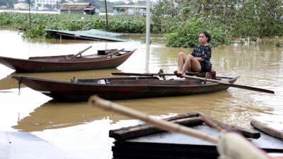 Flash flood sweeps away hamlet as Vietnam storm toll rises to 141 dead - apnews.com - China - Vietnam - Laos - city Hanoi, Vietnam