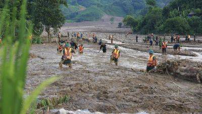 Pham Minh Chinh - HAU DINH - Vietnam typhoon death toll rises to 233 as more bodies found in areas hit by landslides and floods - apnews.com - China - Vietnam - Laos - city Hanoi, Vietnam - parish Red River