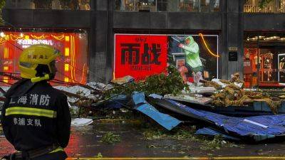 Typhoon knocks out power to some homes in Shanghai as it weakens inland