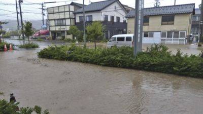 Japan orders evacuations as heavy rains trigger floods in quake-hit region