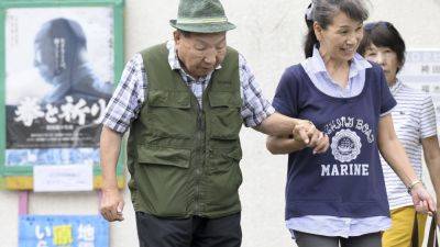 Japanese court acquits a former boxer in a 1966 murder retrial after decades on death row