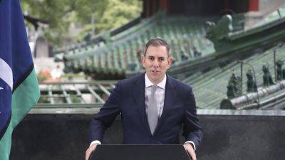 Australian treasurer, visiting Beijing, welcomes Chinese efforts to stimulate its economy